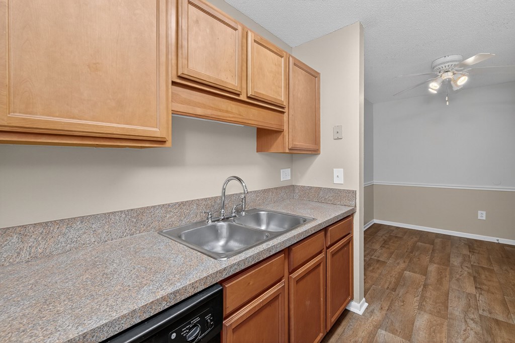 A kitchen with wooden cabinets and a granite countertop at Brackenbrook Apartments, North Charleston, SC, 29418