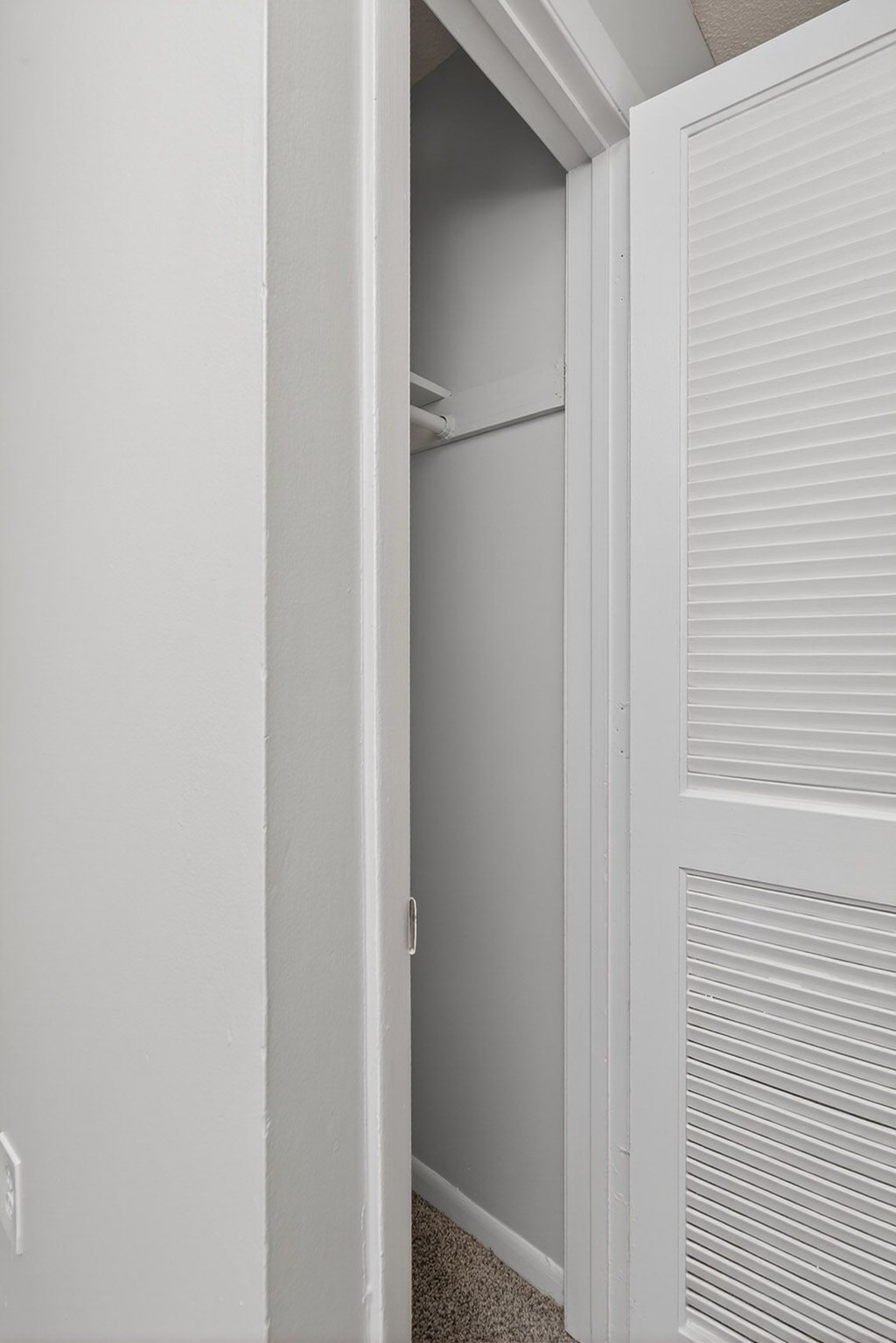 A white closet with a door open at Brackenbrook Apartments, North Charleston