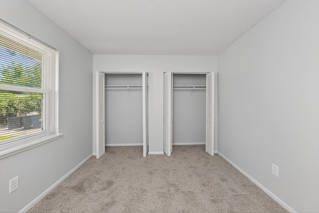 A room with two closets and a window at Brackenbrook Apartments, North Charleston 29418