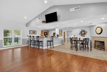 A modern open floor plan with a bar area and a fireplace at North Bluff Apartments, South Carolina