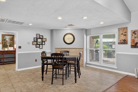 A dining room with a table set for four at North Bluff Apartments, South Carolina, 29406