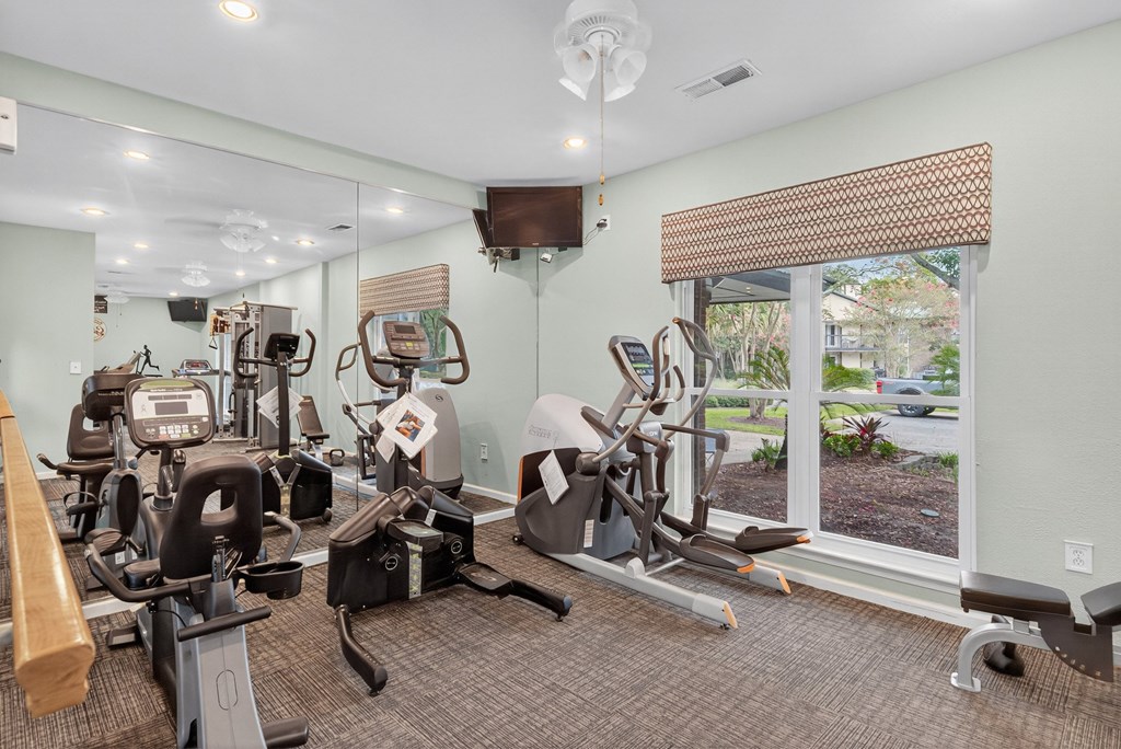 A well-equipped gym with a variety of exercise machines at North Bluff Apartments, North Charleston, SC, 29406