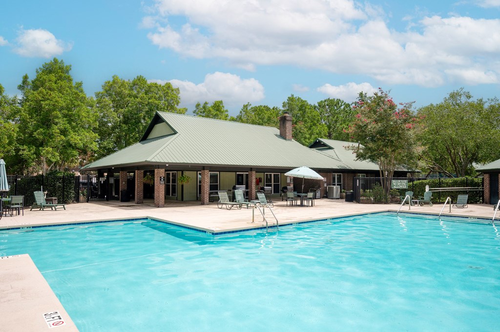 A large swimming pool in front of a house with a green roof at North Bluff Apartments, North Charleston, SC, 29406