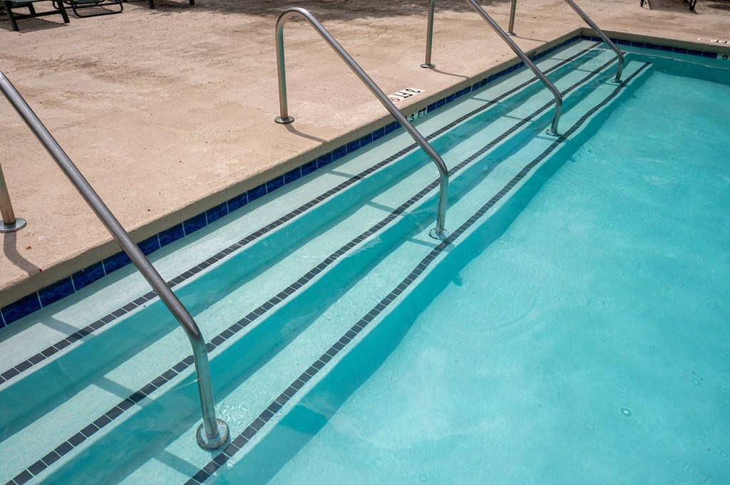 A pool with a metal ladder at North Bluff Apartments, North Charleston, SC