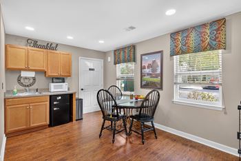 A kitchen with a dining table and chairs at Sawbranch Apartments, South Carolina