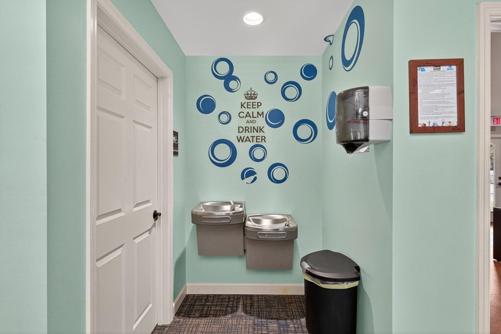 A bathroom with a green wall and a white door at Sawbranch Apartments, Summerville