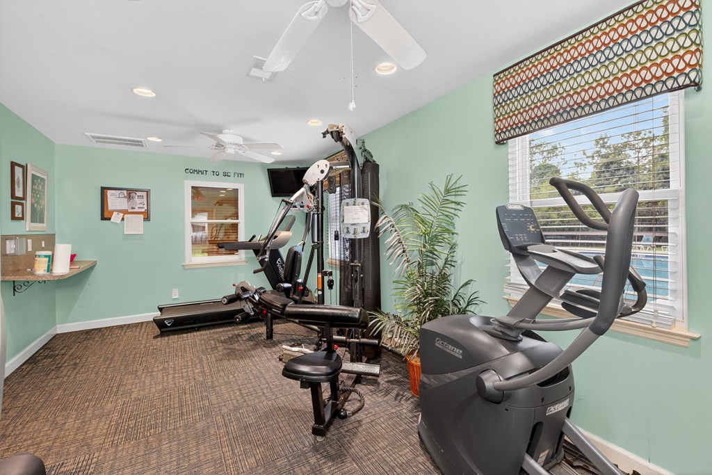 A room with a treadmill, exercise bike, and other equipment at Sawbranch Apartments, Summerville, South Carolina