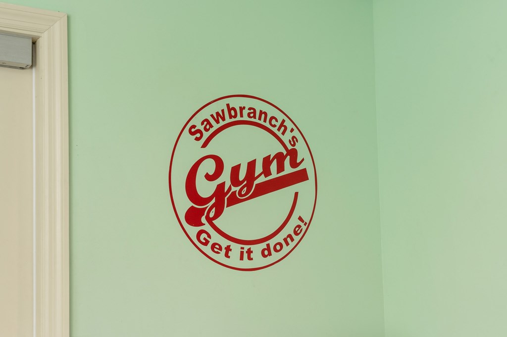 A wall with a Sawbranch Gym sign on it at Sawbranch Apartments, Summerville, SC