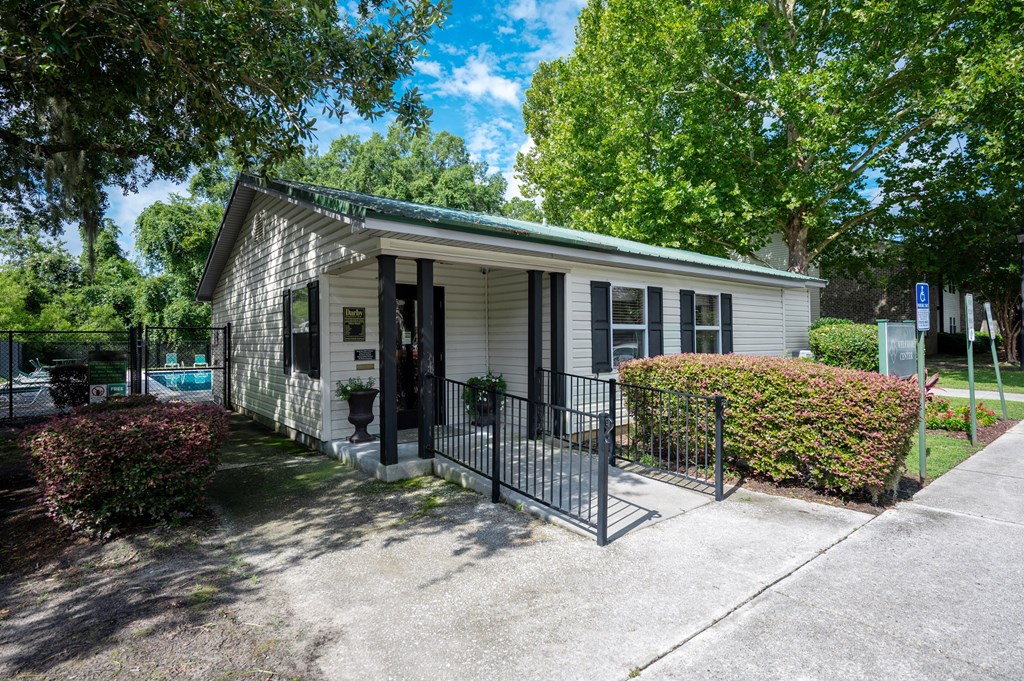 A small house with a black fence in front at Sawbranch Apartments, Summerville, SC