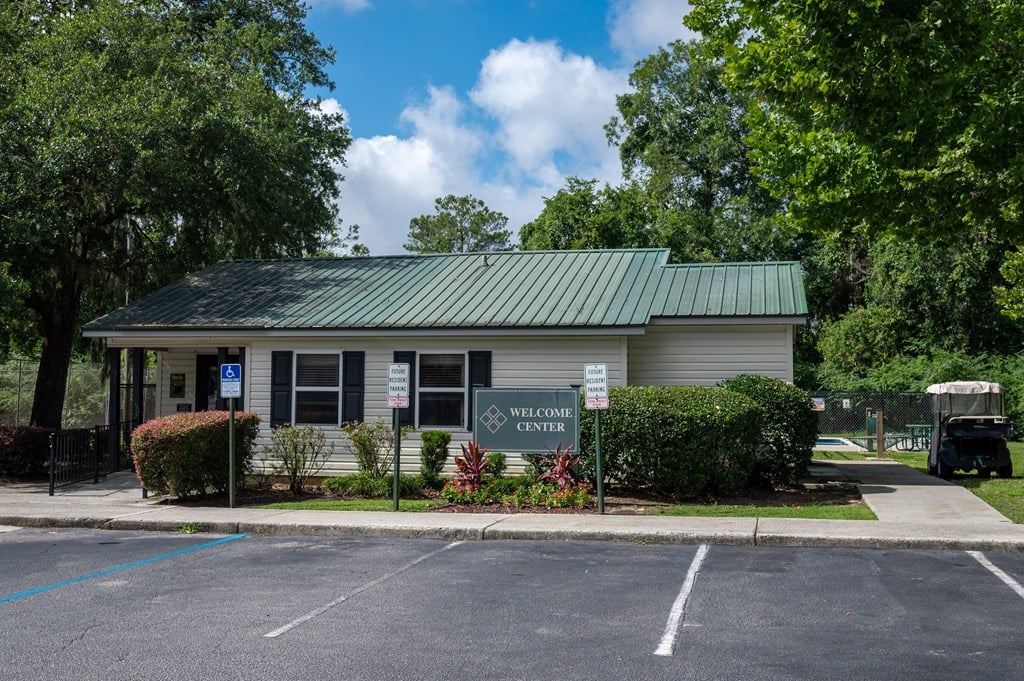A building with a green roof and a sign at Sawbranch Apartments, Summerville, South Carolina