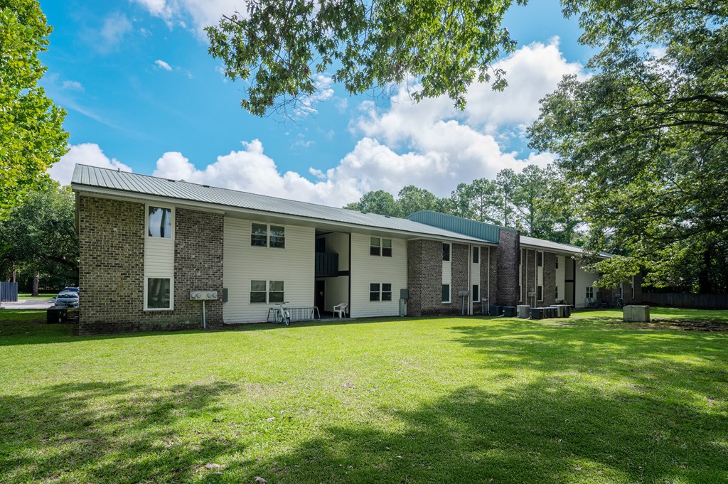 A house with a green lawn in front of it at Sawbranch Apartments, Summerville