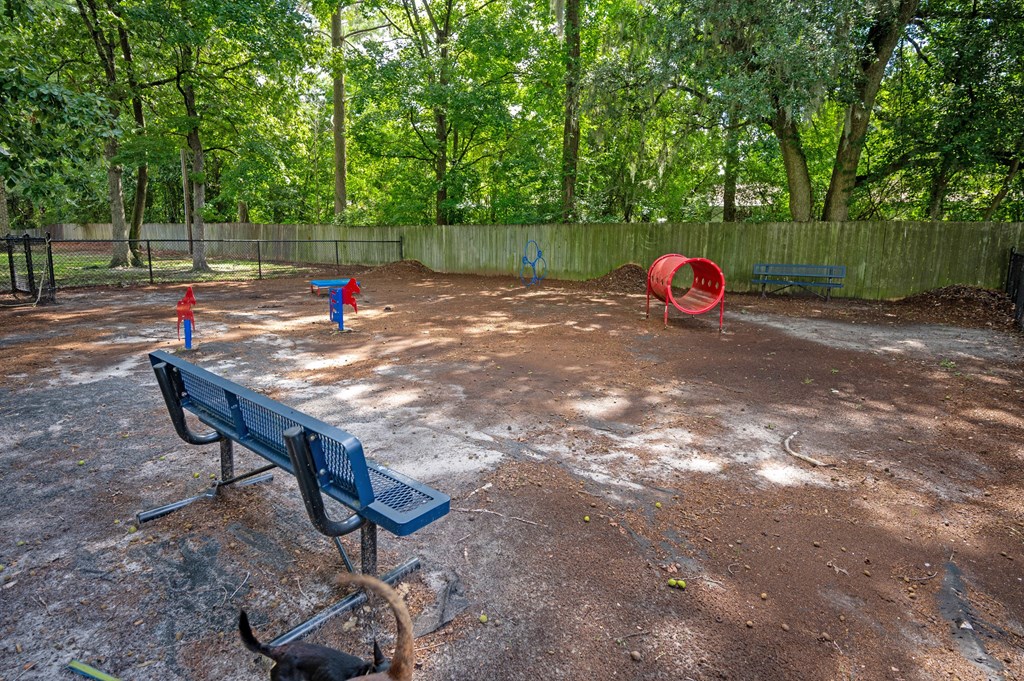 A playground with a blue bench and a red tunnel at Sawbranch Apartments, Summerville, South Carolina