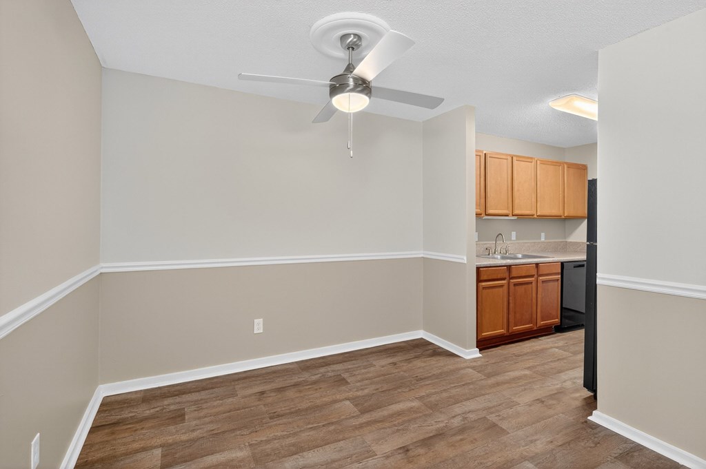 A room with a ceiling fan and wooden flooring at Sawbranch Apartments, Summerville, South Carolina