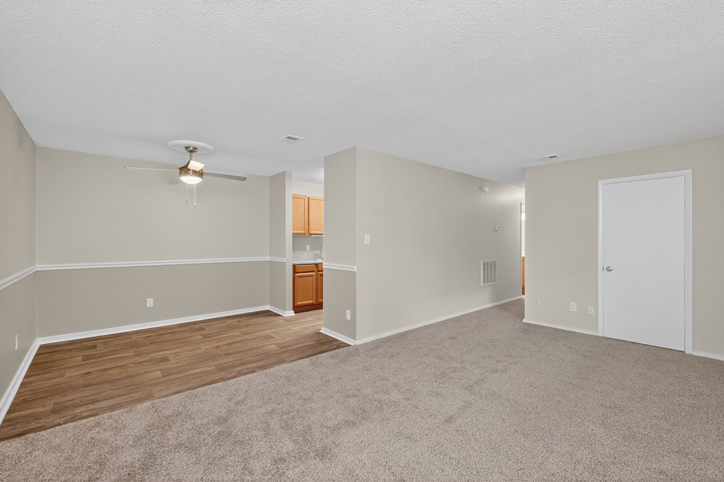 A spacious room with a ceiling fan and lighting fixture at Sawbranch Apartments, Summerville, SC, 29485