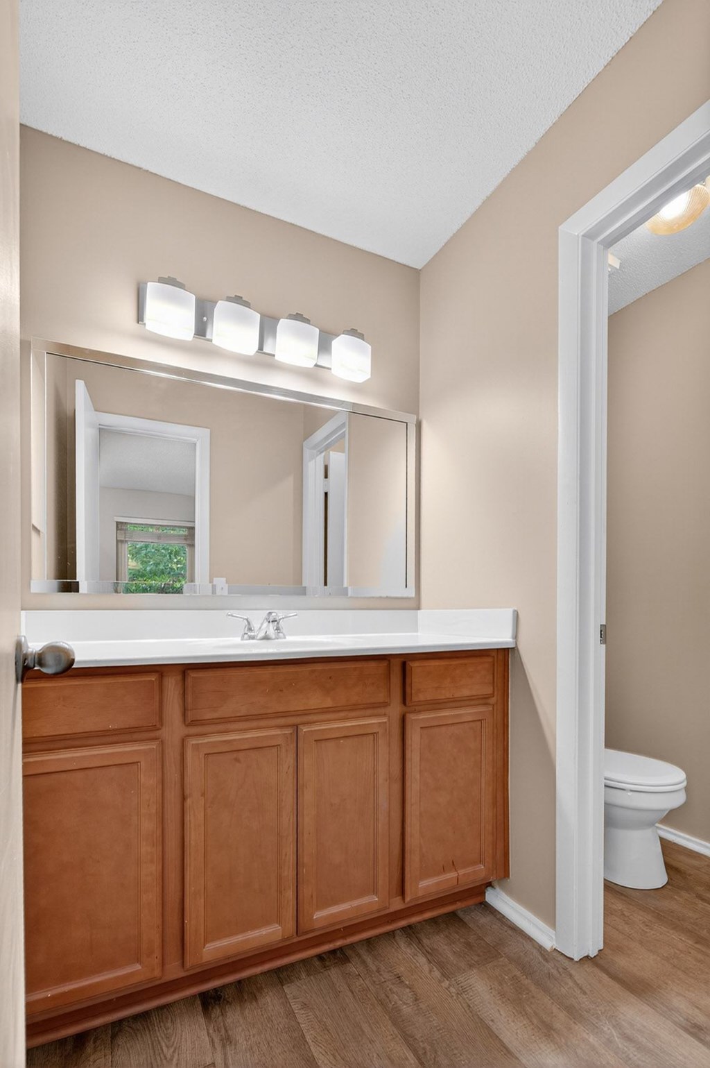 A bathroom with a white countertop and a wooden cabinet at Sawbranch Apartments, Summerville, South Carolina