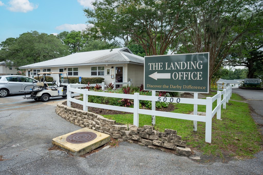 A sign for the landing office is in front of a house at The Landing Townhomes Apartments, Hanahan, SC, 29410