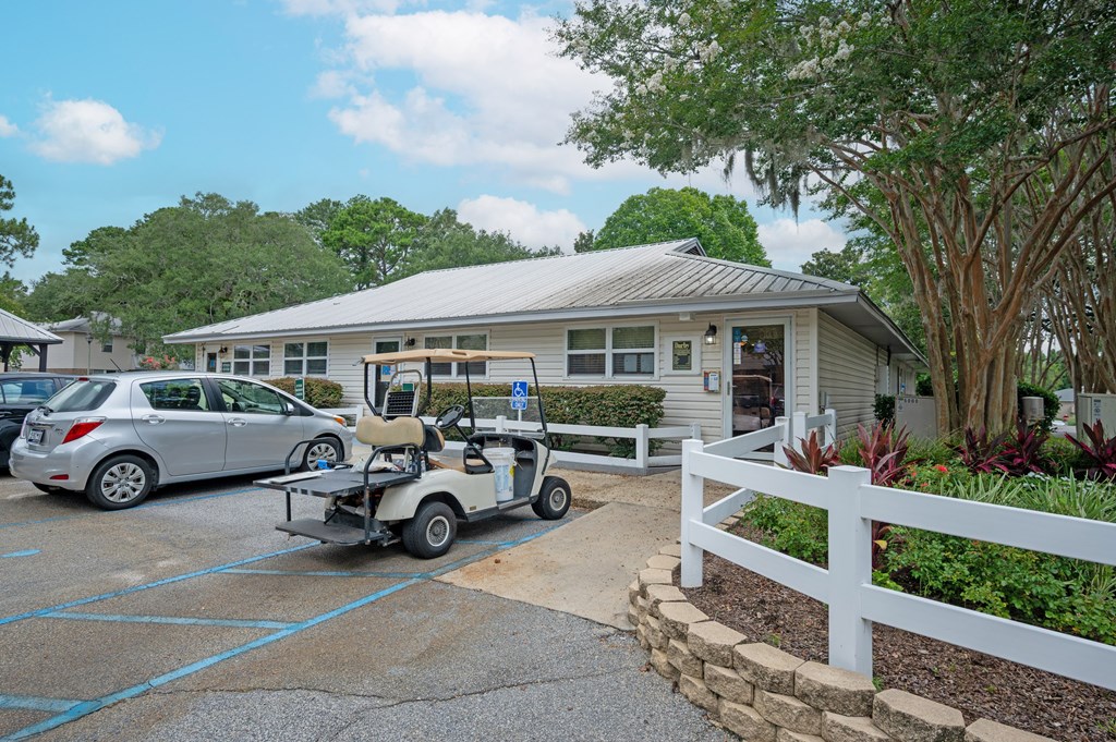 A golf cart is parked in front of a building at The Landing Townhomes Apartments, Hanahan, SC