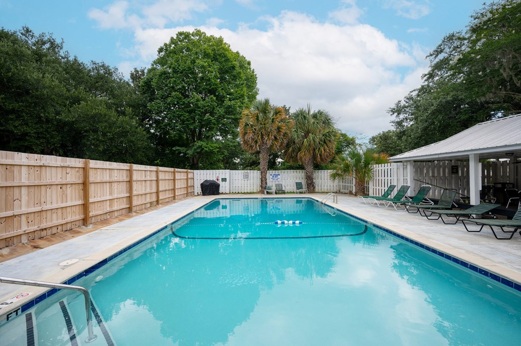 A rectangular pool with a blue tinted water at The Landing Townhomes Apartments, Hanahan 29410