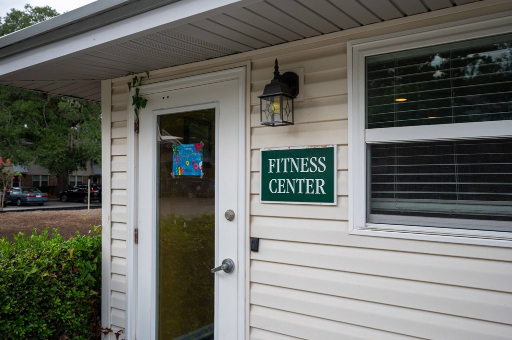 A small white building with a sign that says Fitness Center at The Landing Townhomes Apartments, Hanahan 29410