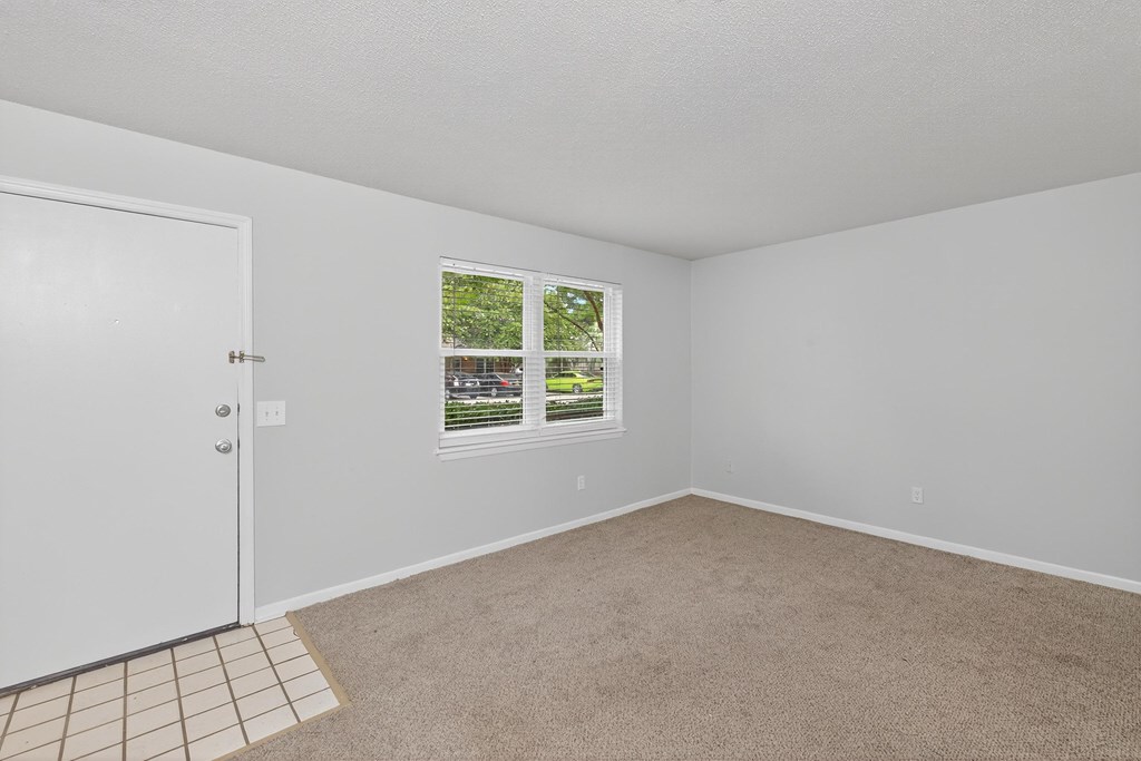 A room with a white door and a window with blinds at The Landing Townhomes Apartments, Hanahan 29410