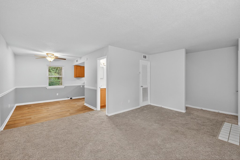A room with white walls and a window with a view of trees at The Landing Townhomes Apartments, Hanahan, SC