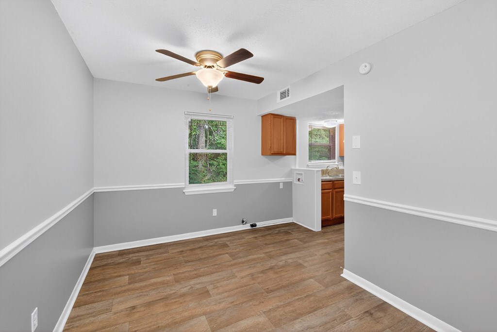 A room with a ceiling fan and a window at The Landing Townhomes Apartments, South Carolina