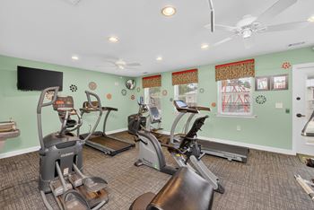 A room with exercise equipment and a television. at Woodlocke Apartments, South Carolina