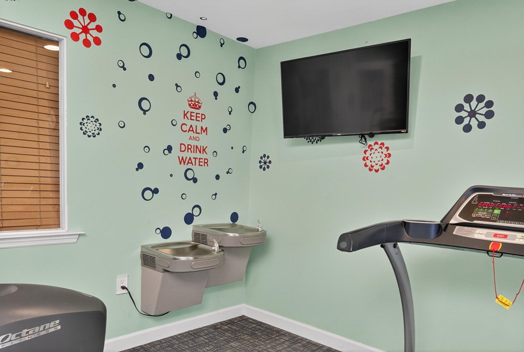 A wall with a sign that says Keep Calm and Drink Water at Woodlocke Apartments, South Carolina