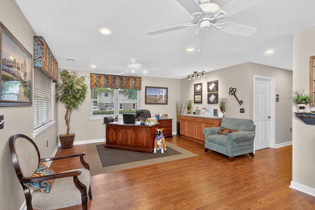 A dog is sitting on a rug in a living room at Woodlocke Apartments, South Carolina, 27461
