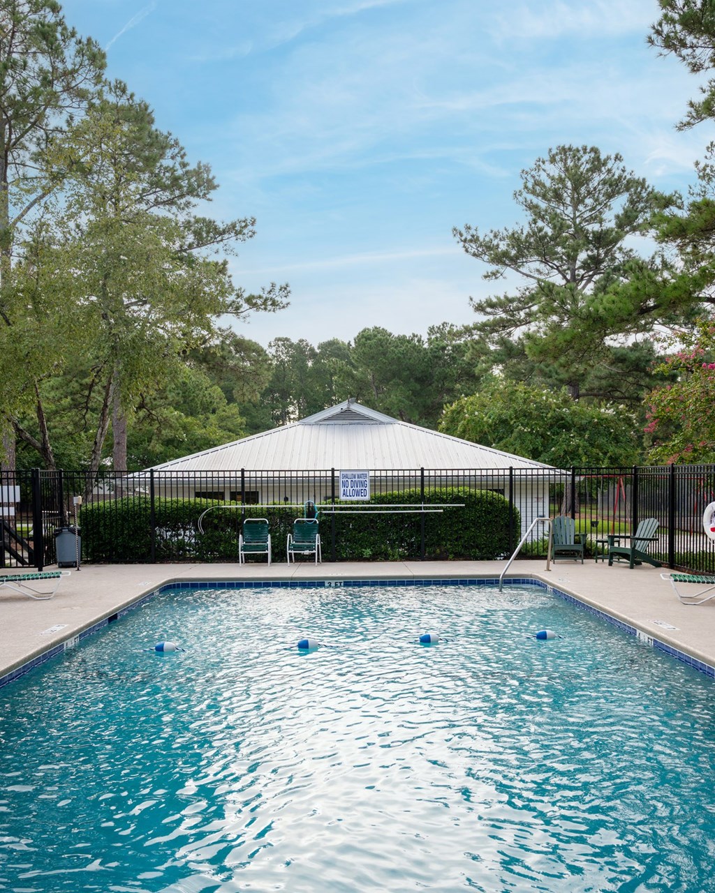 A pool with a white tent in the background at Woodlocke Apartments, Moncks Corner, South Carolina