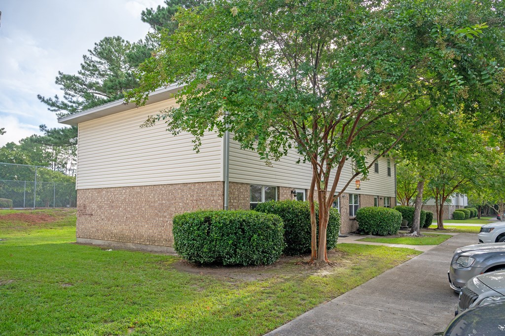 A building with a tree in front of it at Woodlocke Apartments, South Carolina