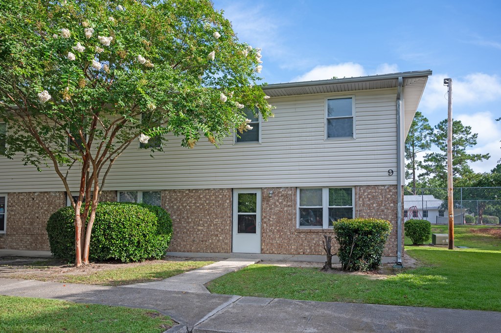 A house with a tree in front of it at Woodlocke Apartments, Moncks Corner, SC