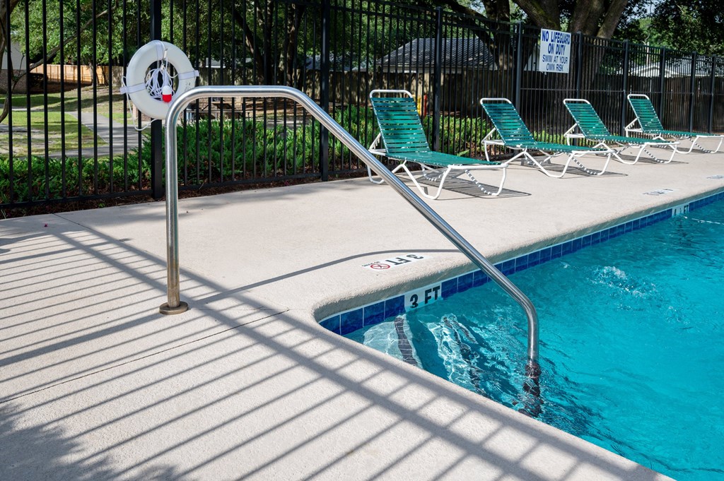 A pool with a 2 ft depth marker at Woodlocke Apartments, Moncks Corner 27461