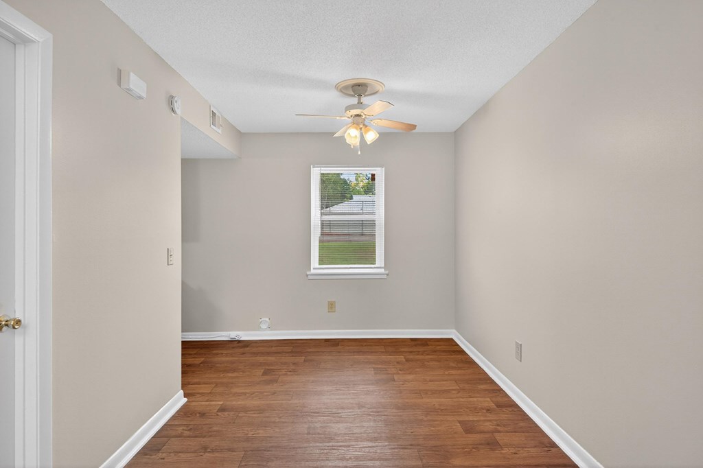 A room with a window and a ceiling fan at Woodlocke Apartments, Moncks Corner 27461
