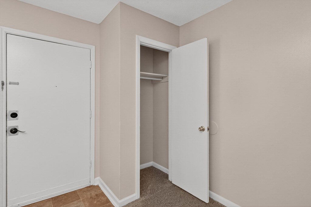 A white door is closed and another is open at Woodlocke Apartments, Moncks Corner, SC