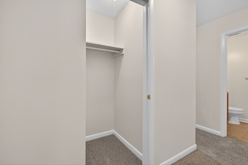 A white door is in a room with white walls at Woodlocke Apartments, Moncks Corner, SC