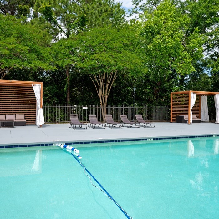 A pool with a blue rope in the middle of it at The Preserve at Pine Valley Apartments, North Carolina 28412