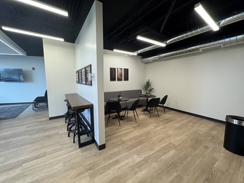 A conference room with a long table and chairs.