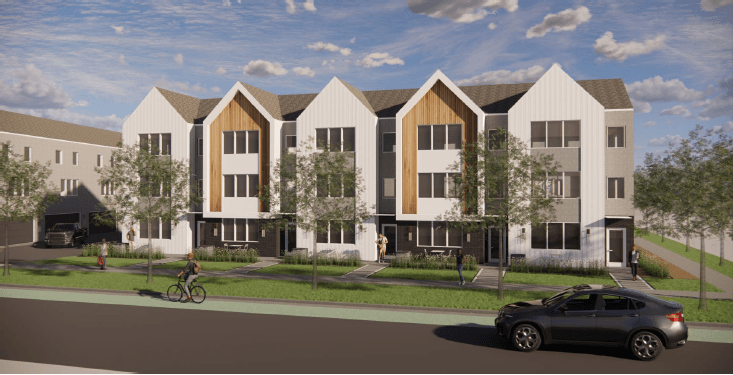 A modern apartment complex with a car parked in front.