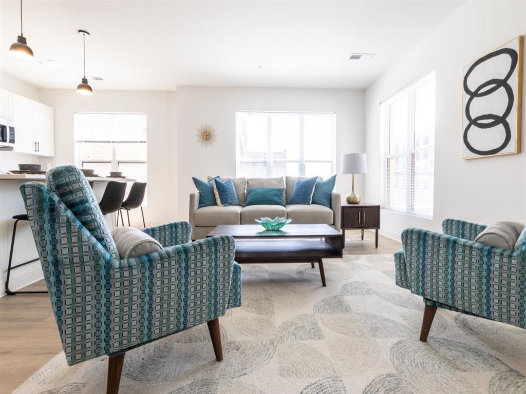 A living room with a patterned chair and a patterned sofa.