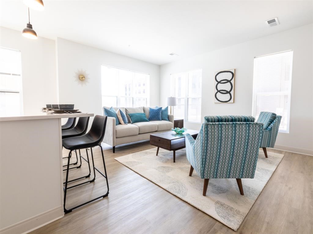 A living room with a sofa, chairs, and a coffee table.