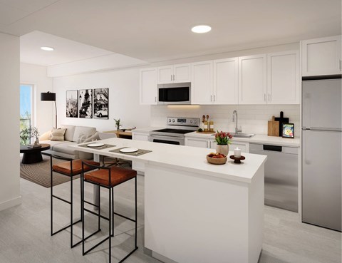 A modern kitchen with white cabinets and a large island.