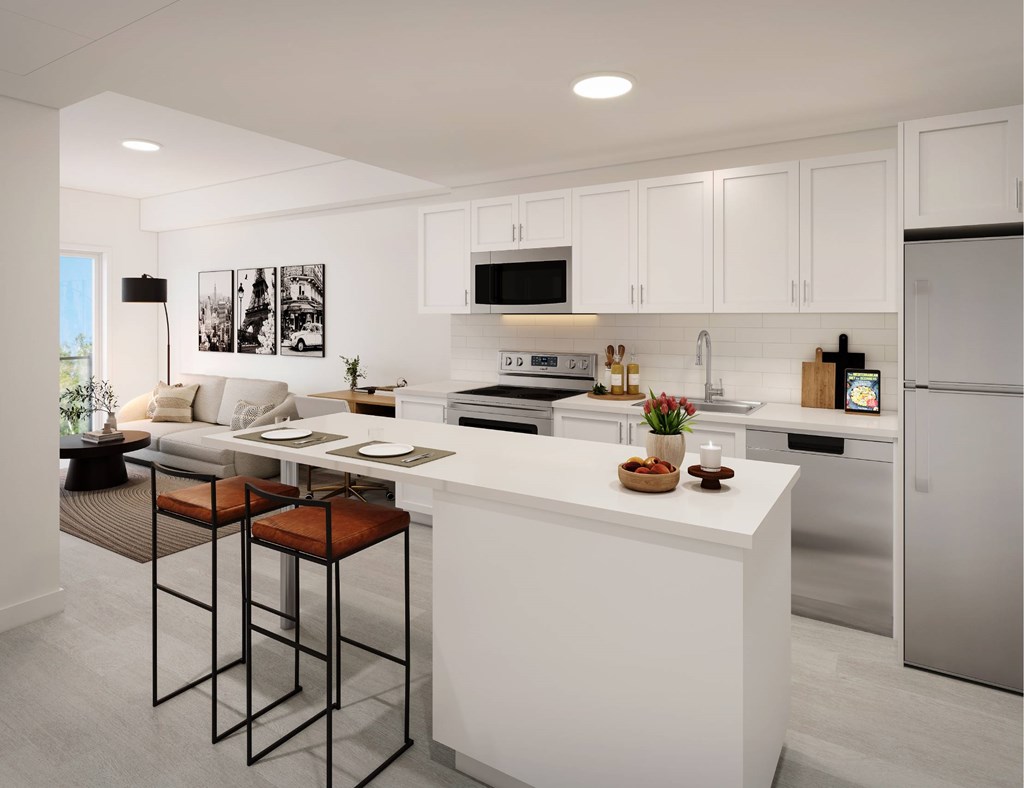 A modern kitchen with white cabinets and a large island.