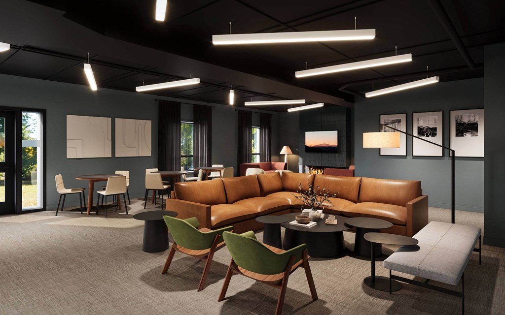 A modern living room with a brown leather sofa and green chairs.