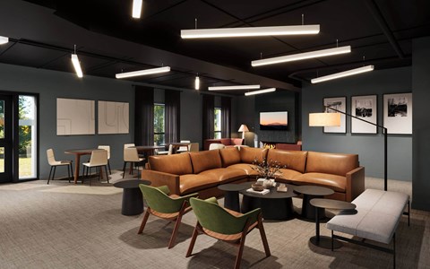 A modern living room with a brown leather sofa and green chairs.