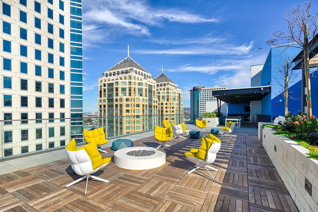A rooftop patio with yellow chairs and a fire pit.at Eleven Fifty Clay Street, California, 94607