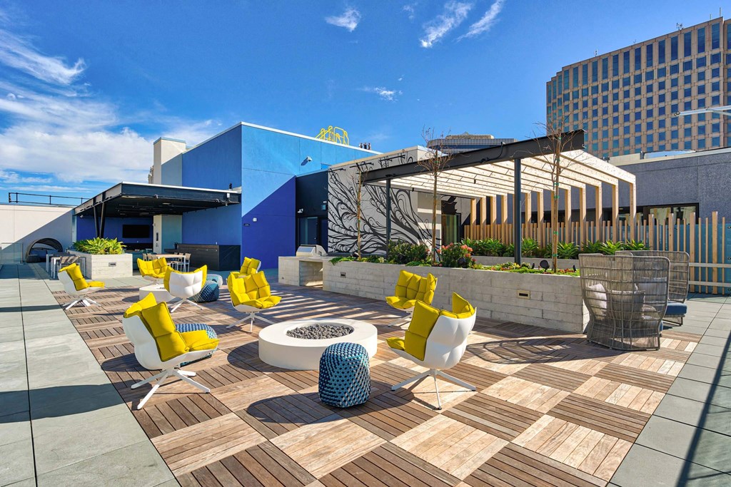 A modern outdoor seating area with yellow chairs and a white table.at Eleven Fifty Clay Street, California  