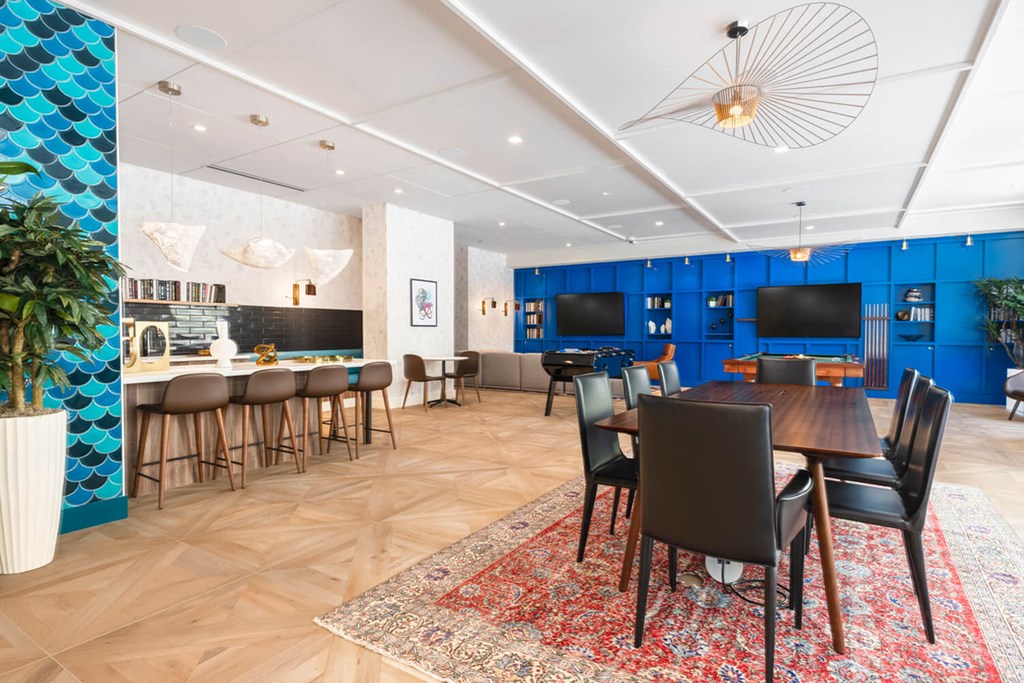 A dining room with a wooden table surrounded by chairs.at The Vale at the Parks, Washington District of Columbia  