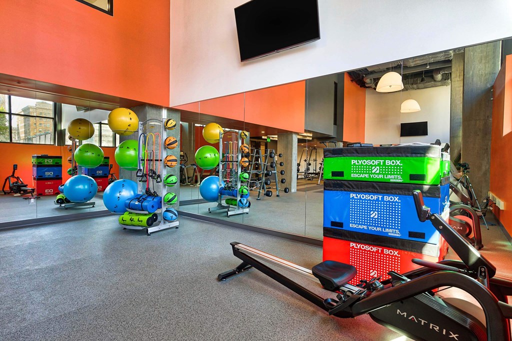 A gym with a variety of equipment including a rowing machine.at Eleven Fifty Clay Street, California, 94607