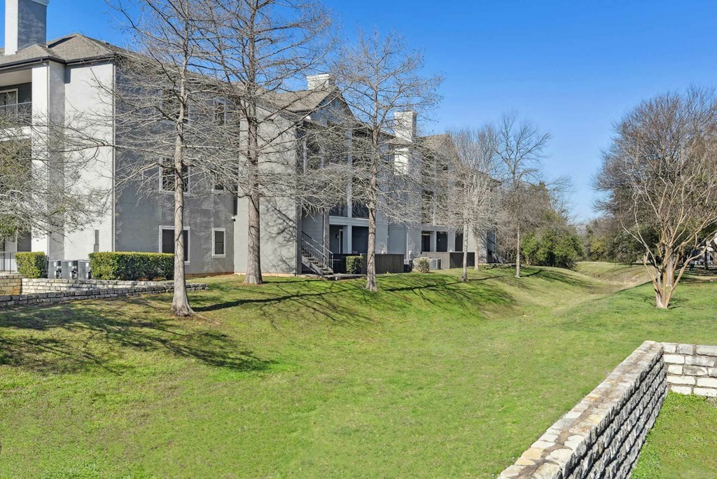 A large building with a grassy area in front of it. A large building with a grassy area in front of it.at Onyx183, Austin, TX 78729